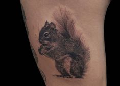 a small squirrel tattoo on the thigh