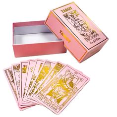 a pink box with four cards in it and the inside is open to show them