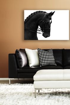 a black and white photo of a horse head on a wall above a couch in a living room