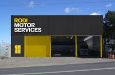 a yellow and black building with the words rodi motor services on it