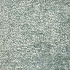 an area rug is shown in shades of blue and green, with small dots on the ground