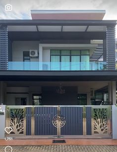 a house that is painted blue and has an iron gate in front of the door