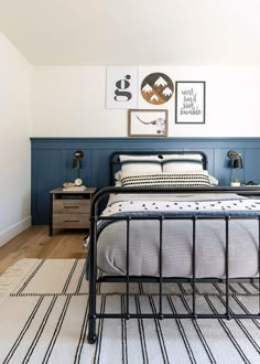 a bed room with a neatly made bed and pictures on the wall