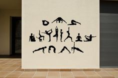 the silhouettes of people doing yoga on a white wall in front of a building