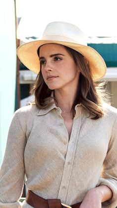 a woman wearing a white hat and dress shirt