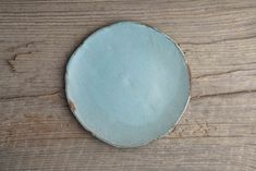 a blue plate sitting on top of a wooden table