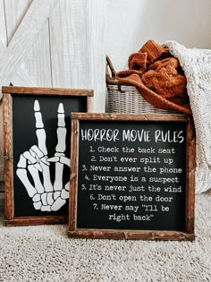 two wooden signs with hand prints on them sitting next to a basket full of bread