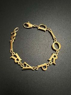 DIOR PARIS women's monogram bracelet. The bracelet is used, in good condition, length 20 cm. Sold without a box. Dior Paris, Monogram Bracelet, Paris Woman, Chain Link Bracelet, Link Bracelets, A Box, Arm Band, Chain Link, 20 Cm