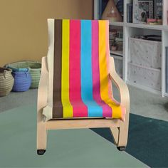 a multicolored chair sitting in front of a book shelf