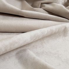 a close up view of a plain white fabric with very soft, wrinkled edges