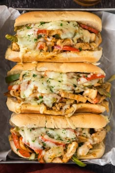 three sub sandwiches sitting on top of each other