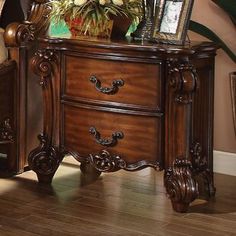 a wooden dresser with pictures on top of it