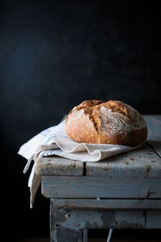 a loaf of bread sitting on top of a wooden table