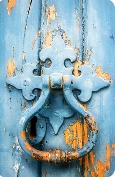 an old blue door with rusted metal handle on it's front and side