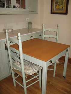 a kitchen table with two chairs around it