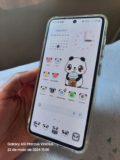 a person holding an iphone in their hand with panda stickers on the display screen