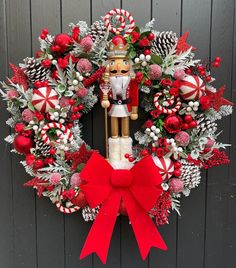 a wreath with a nutcracker and candy canes