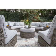 an outdoor patio furniture set with grey cushions