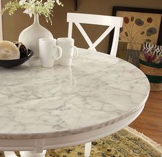 a marble table with white chairs around it