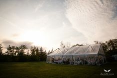 a large tent set up in the middle of a field