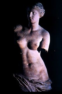 a statue is shown in the dark with dirt on it's body and chest