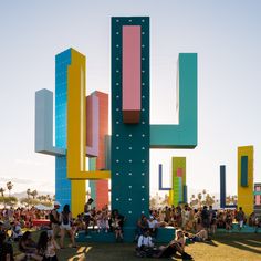 people are sitting in front of a colorful sculpture