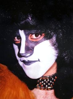 a man with black and white makeup on his face