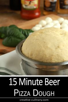 a pizza dough sitting in a bowl on top of a table