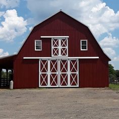 a red barn with white windows and doors