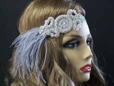 1920s headpiece, Flapper headband, Great Gatsby headpiece, Feather headband, Downton Abbey, Rhinestone Art Deco, 1920s hair accessory This stunning 1920's Downton Abbey vintage inspired Art Deco flapper headband is the perfect accompaniment for any styled event. Features a a beautiful hand stitched centerpiece with brilliant crystal  rhinestones and silver seed beads.  The centerpiece measures 5X2 inches. This beautiful centerpiece is hand sewn onto a silver satin elastic headband. So easy to slip on and off and can be worn on either side of your head. The centerpiece is completely lined with eco-felt for a clean finish.  I added a flurry of silver/gray Ostrich feathers from one side. Each piece is designed and uniquely made one at a time with much thought, time and love. In most cases the 1920s Hair Accessories, Great Gatsby Headpiece, Gatsby Headpiece, 1920s Headpiece, 1920s Hair, Flapper Headband, Vintage Inspired Art, Art Deco 1920s, Feather Headband