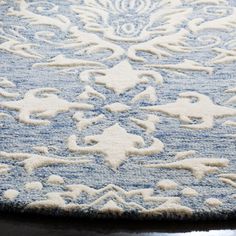 a blue and white rug with an intricate design