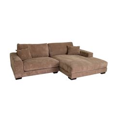 a brown sectional couch with pillows on it