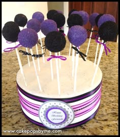 cake pops with purple and black decorations on top