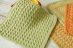 crocheted dishcloths are sitting on the floor next to a yellow object