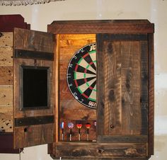 an old wooden cabinet with darts in it