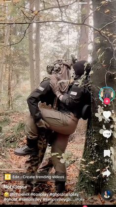 two people in the woods with backpacks on their back and one person holding onto a tree