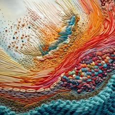 a close up view of a colorful piece of art made out of yarn and thread