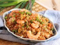 a bowl filled with shrimp and rice on top of a table