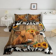 a cow with sunflowers on it's head is shown in this bedding set