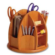 a wooden desk organizer with scissors, pens and pencils in the holder on top