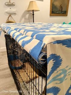 a blue and white blanket on top of a cage