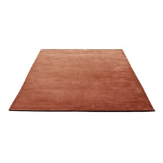 an orange rug on a white background with no one in the room to see it