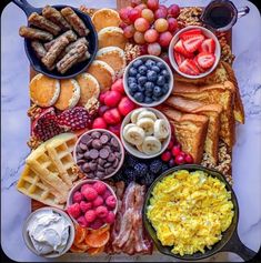 an assortment of breakfast foods arranged on a platter