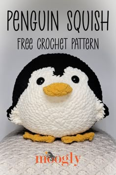 a penguin stuffed animal sitting on top of a white blanket with the words penguin squish free crochet pattern