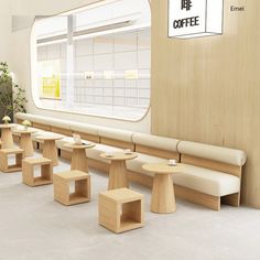 an empty coffee shop with wooden benches and tables