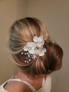 "This beautiful flower faux pearl and crystal hair clip will add a stunning accent on your big day! The flowers and leaves are a matte white resin accented with pearls and crystal branches. The wire is silver and the clip design makes this hair peace very versatile and easy to use! The clip features a spray of white flowers and leaves, with pearl and crystal accents. The design is simple, yet stunning with the crystal centers. Add a touch of elegance and sparkle to your bridal hair with this ele Pearl White Flower-shaped Wedding Jewelry, White Floral Hair Piece, Pearl And Flower Hair Vine, Pearl Hair Vine Wedding, White Rose Hair Clip, White Flower Hair Clip, Pearl Hair Vine, Crystal Hair Clips, Bridesmaid Hair Accessories