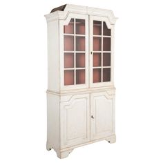 a white china cabinet with glass doors on the top and bottom shelves, in front of a white background