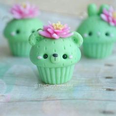 three small green cupcakes with flowers on top