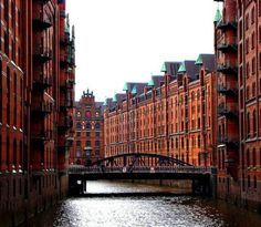 a bridge over a body of water between two buildings