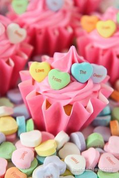 colorful candy hearts and candies with the words love from the cupcakes written on them